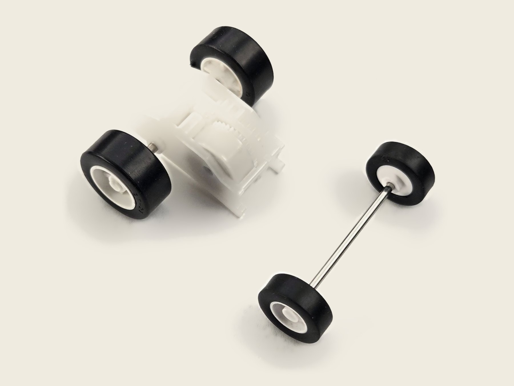 Brute pull-back motor with its matching 16 mm front wheel-and-axle set, its front wheels visibly smaller than the driven rear wheels