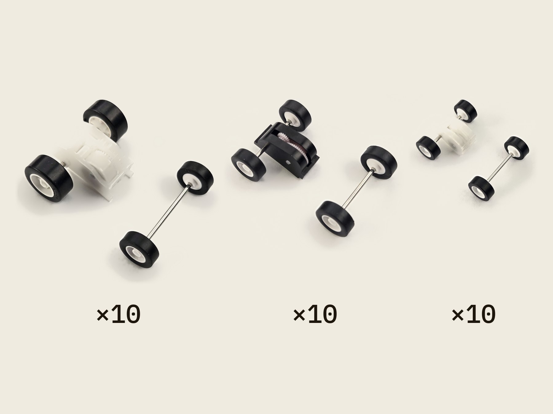 Thirty pull-back motors, ten of each size in rows from largest to smallest, with their matching front wheel-and-axle sets