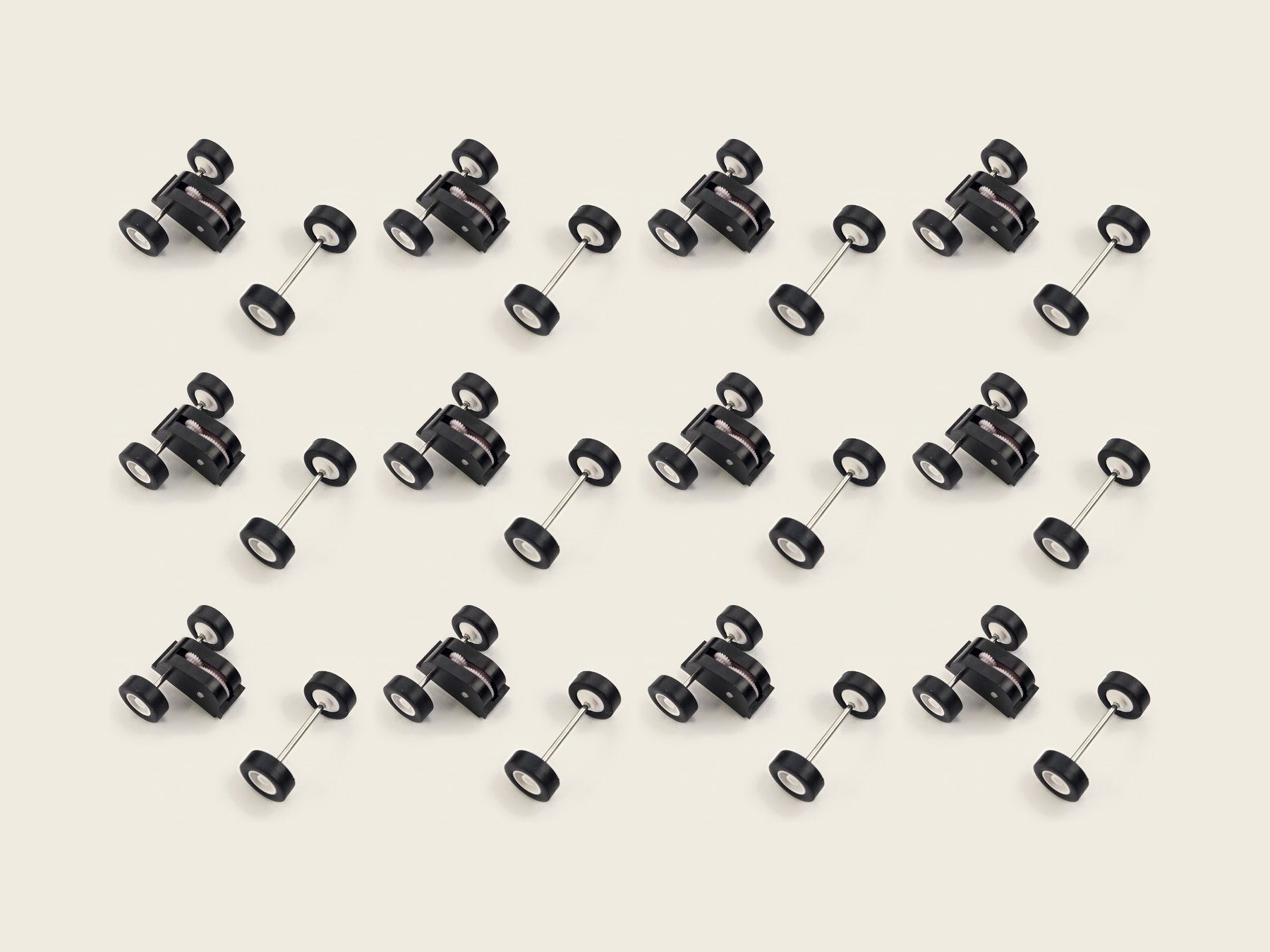 Twelve Stout pull-back motors with their matching front wheel-and-axle sets